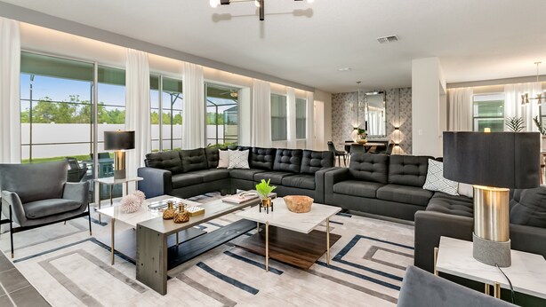 A modern living room with a sectional sofa, a coffee table, and a chandelier. - 1834cvt New Solara 9 Bedroom 6 Bathroom Resort (Kissimmee)