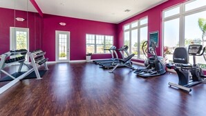 A gym with treadmills, elliptical machines, and weight machines.
