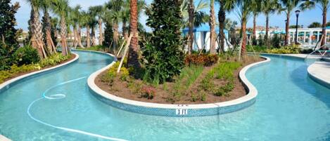 A swimming pool with a 3 ft. depth marker, surrounded by palm trees and a landscaped garden.