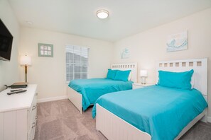 A bedroom with two beds, a desk, and a TV. - Cozy 4 Bed 3 Ba Champions Gate Pool Home1566pd (Davenport)