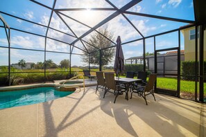 A covered outdoor area with a pool, patio furniture, and a view of the surrounding landscape. - 5 Bedroom 5 Bathroom Solterra Resort Luxury Villa (Davenport)