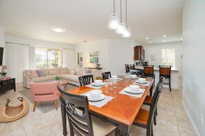A dining area with a wooden table set for six, surrounded by chairs. - 5 Bedroom 5 Bathroom Solterra Resort Luxury Villa (Davenport)