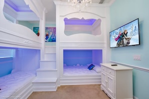 A child's bedroom with bunk beds, a TV, and a dresser. - 5bed 5Ba Reunion Villa w. Pool (Kissimmee)