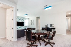 A conference room with a large table and six chairs, a television, and a desk with a computer. - 9 BD 6.5 BH House Villa (Kissimmee)