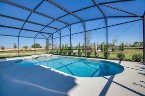 A covered outdoor swimming pool with a clear view of the surrounding landscape. - Cool and Modern 9 Bed 7 Ba Villa Pool & Spa 6160boa (Davenport)