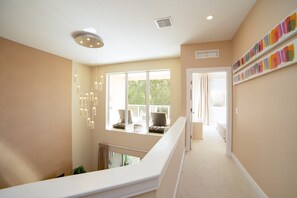 A spacious hallway with a high ceiling, large windows, and a view of the outdoors. - New Magic Villa Resort Townhome 3123bra (Kissimmee)