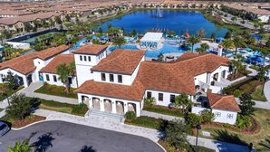 A resort with a large swimming pool, multiple guest villas, and a central water feature. - 5 bed Town Home With Pool (Kissimmee)