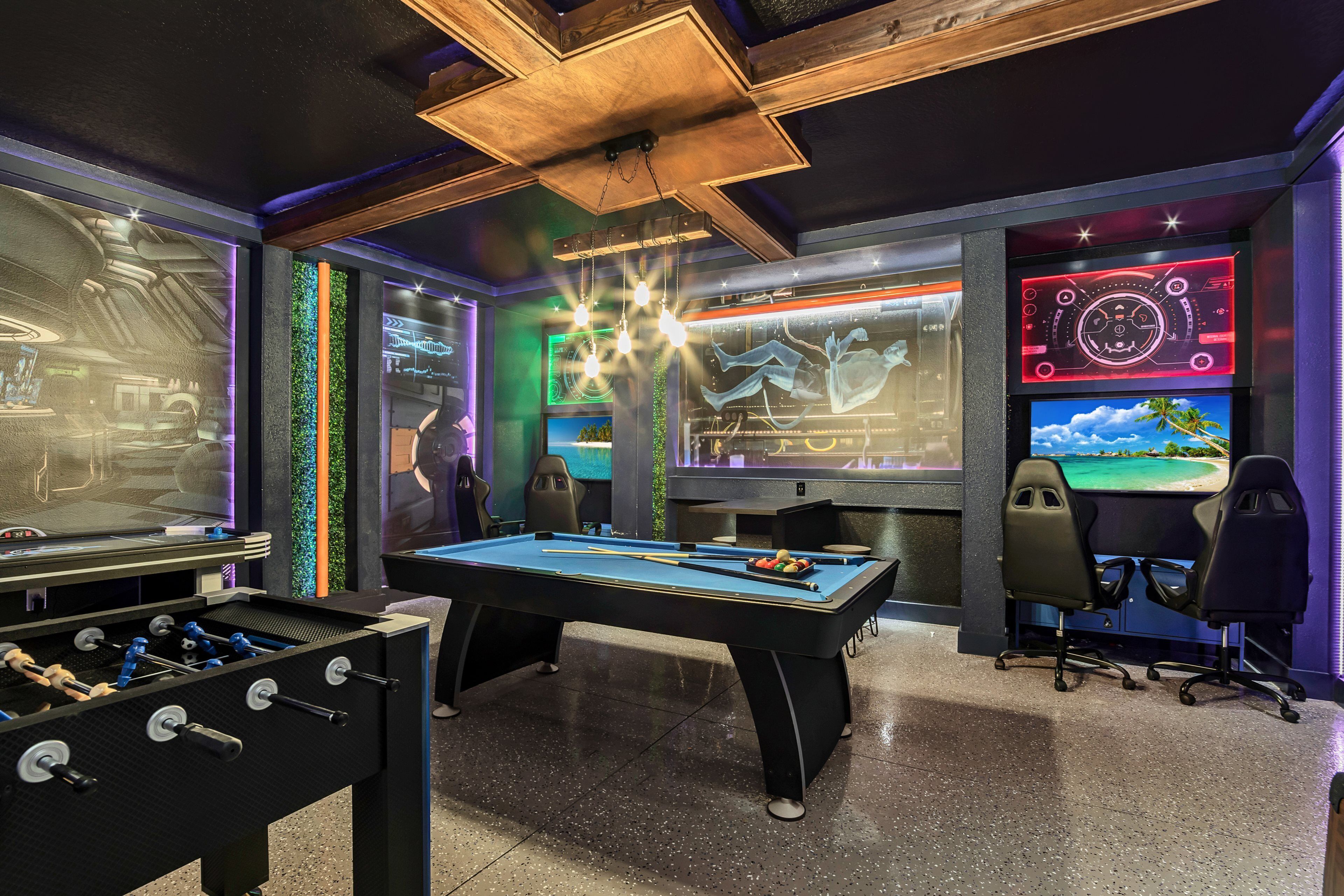 A room with a pool table, foosball table, and gaming chairs.