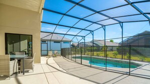 A covered patio with a pool, outdoor furniture, and a view of neighboring houses. - 2360victoria (Davenport)