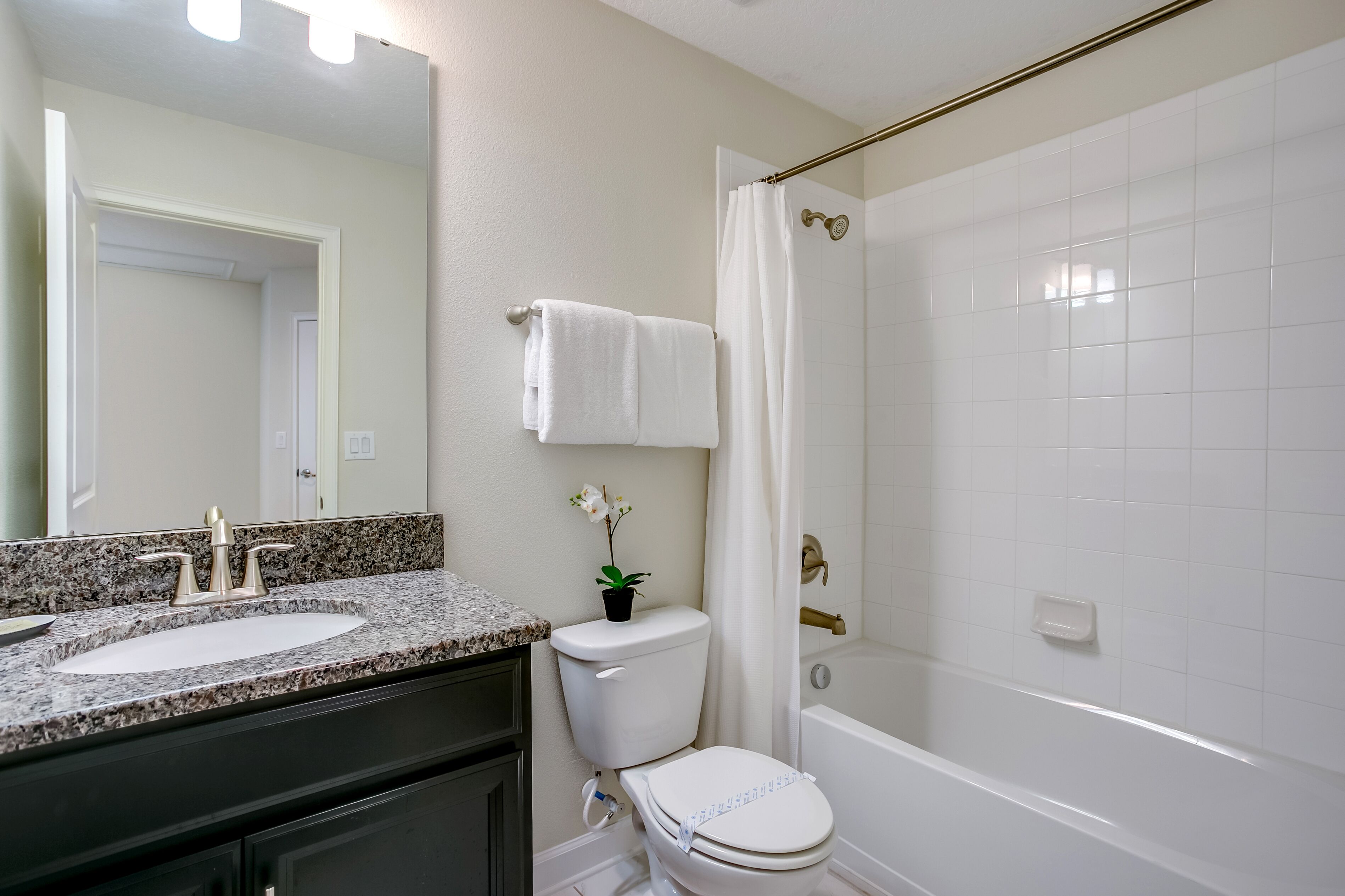 A bathroom with a sink, toilet, and bathtub.
