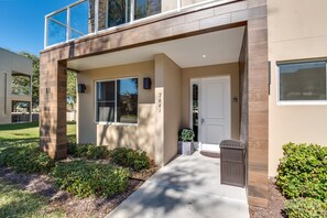 A modern building with a flat roof, large windows, and a clean entrance. - Magic Village Resort 4 Bdrm Townhome (Kissimmee)