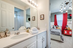 A bathroom with two sinks, a large mirror, and a vanity. - 9 Bdrm 6,5 B Villa W Private Pool (Kissimmee)