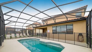 An indoor swimming pool with a glass ceiling, lounge chairs, and a tiled floor. - 2586rose (Davenport)