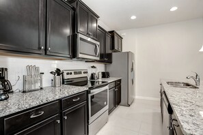 Villa | Private kitchen | Fridge, microwave, highchair, cookware/dishes/utensils
