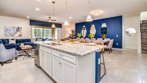 A modern kitchen with a central island, white cabinetry, and pendant lighting. - 8856bengal (Kissimmee)