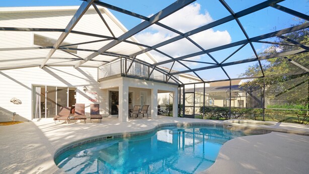 A modern house with a large indoor swimming pool, a covered patio, and a spacious living area. - 2173victoria (Davenport)