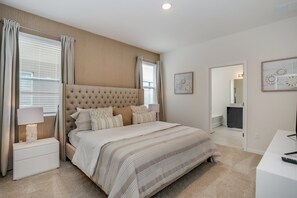 A bedroom with a large bed, a nightstand, a desk, and a dresser. - 6bed 4Ba Villa Game Room Pool Spa (Davenport)
