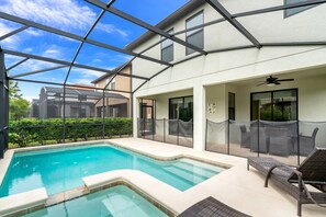 A swimming pool with a glass enclosure, outdoor furniture, and a ceiling fan. - 6bed 5Ba Villa Game Room Pool Spa (Davenport)