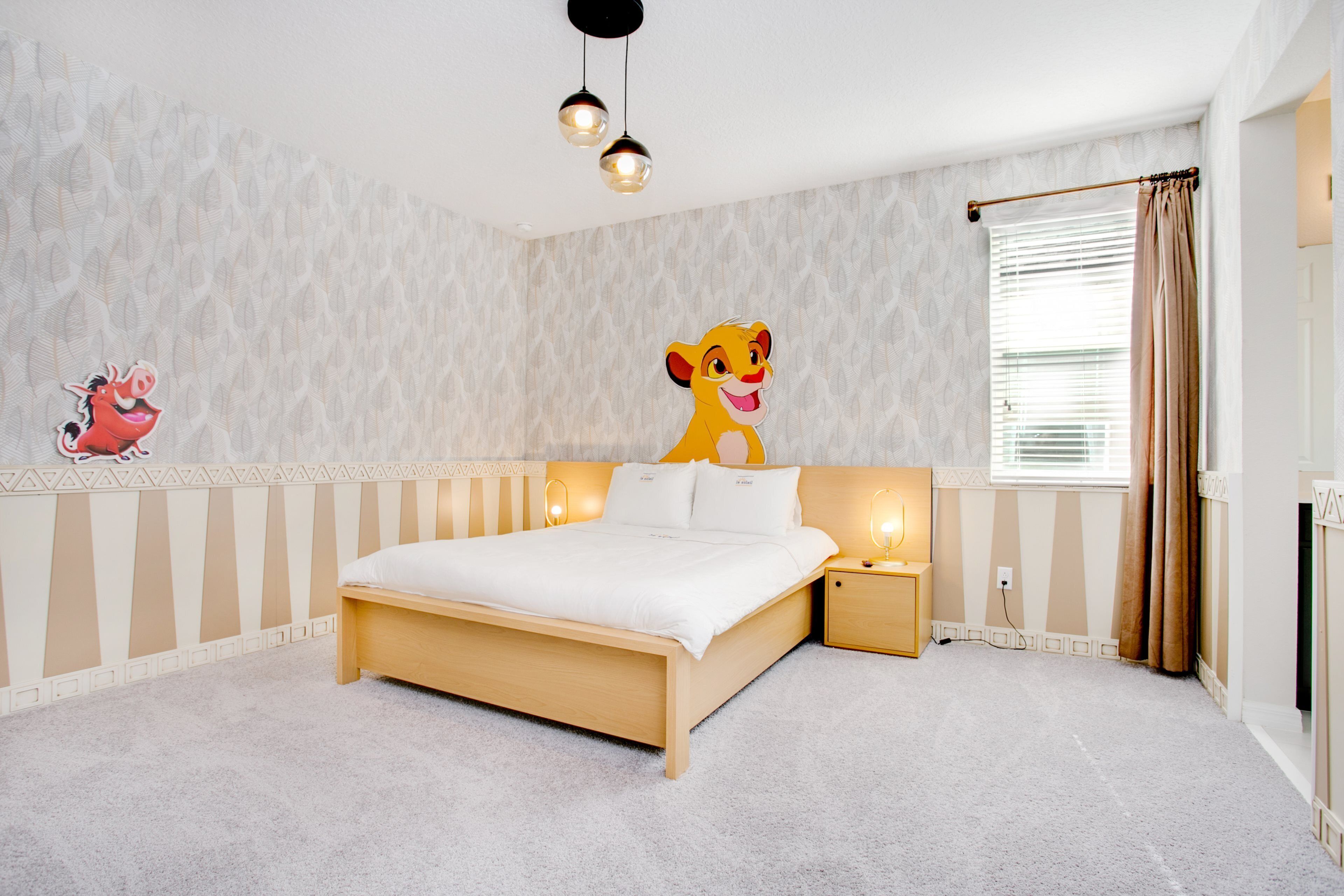 A bedroom with a large bed, a nightstand, a wall-mounted shelf with a cartoon character, and a window with curtains.