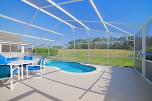 A covered outdoor swimming pool with a clear view of the surrounding landscape. - 204glen (Davenport)