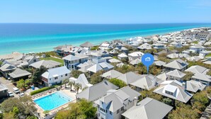 A coastal residential area with houses, a swimming pool, and a view of the ocean. - Sandpiper Cottage - Four Bedroom Close to Pool & Beach (Rosemary Beach)