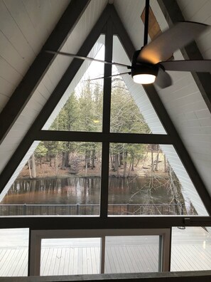 Enjoy a tranquil view of the water and surrounding trees from the large window.