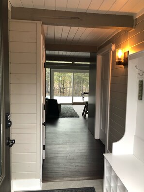 Enter a serene space with a large window and a cozy bench, perfect for relaxation.