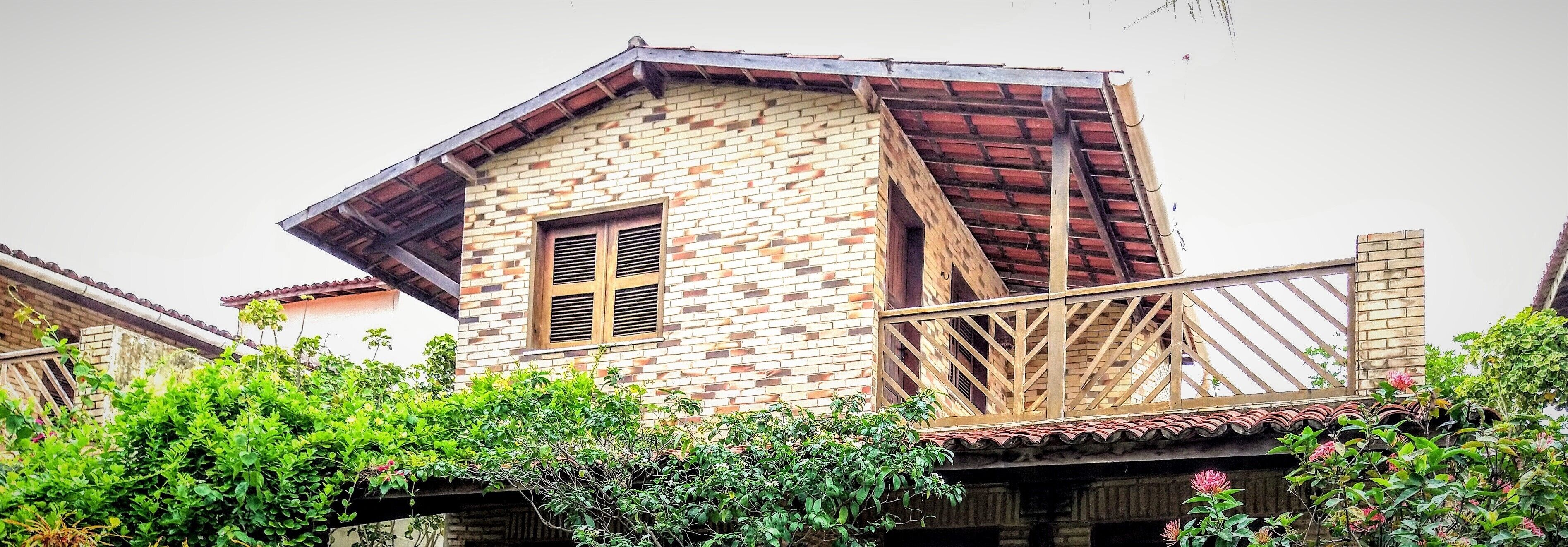 A two-story building with a brick facade and a sloped roof.
