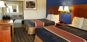 A hotel room with two beds, a desk, a chair, a sink, and a mirror. - Executive Inn (Victoria)