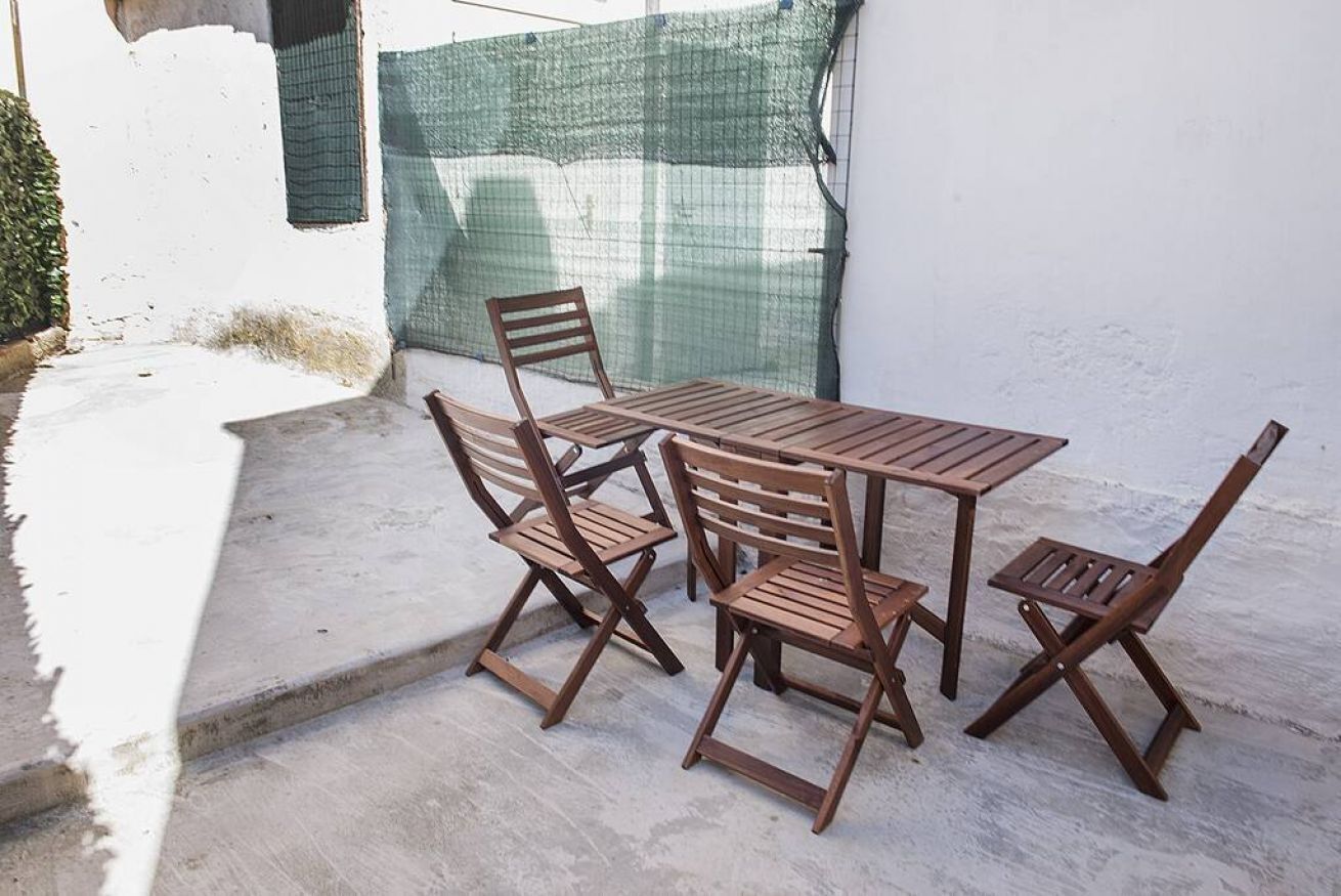 A patio with a table and four chairs.