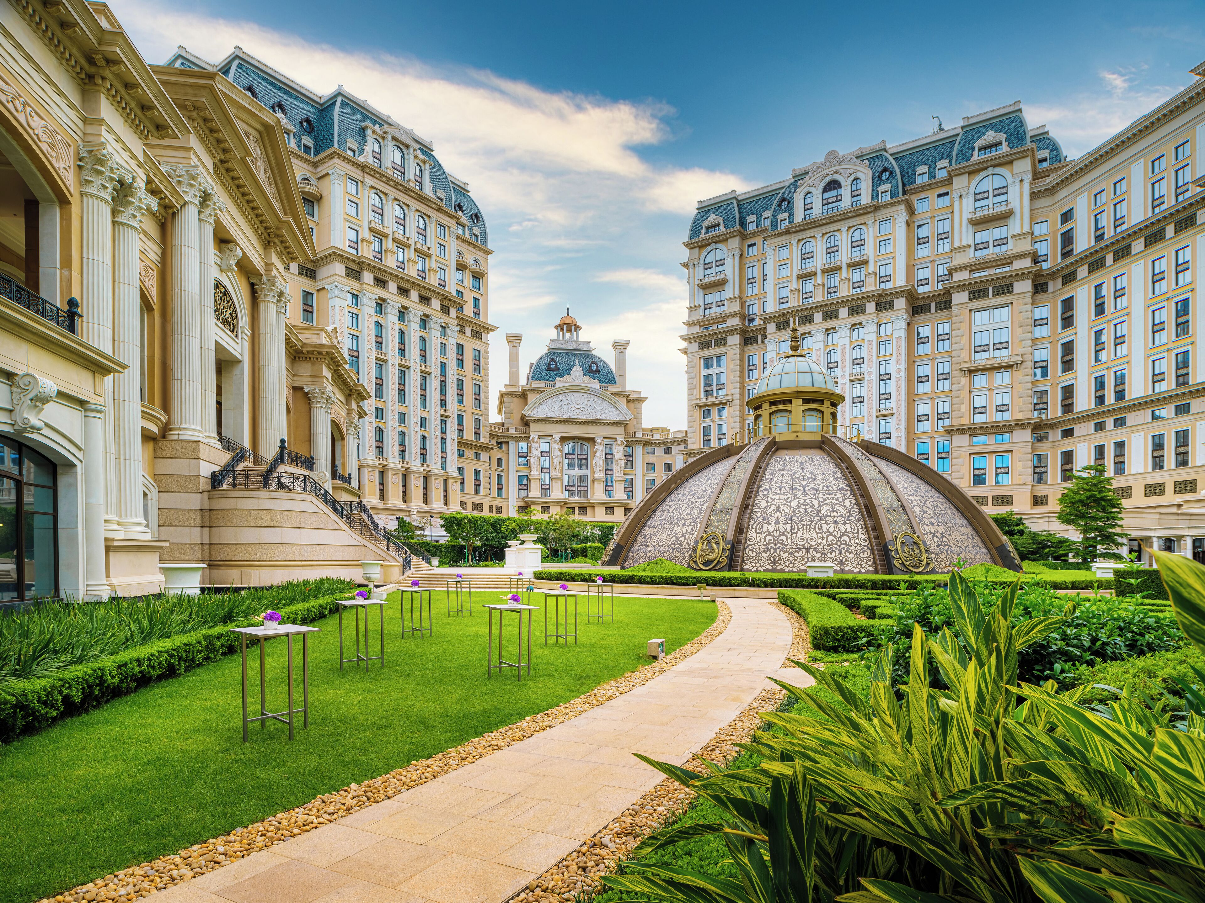 A grand hotel with classical architecture, featuring a central dome and symmetrical building design.