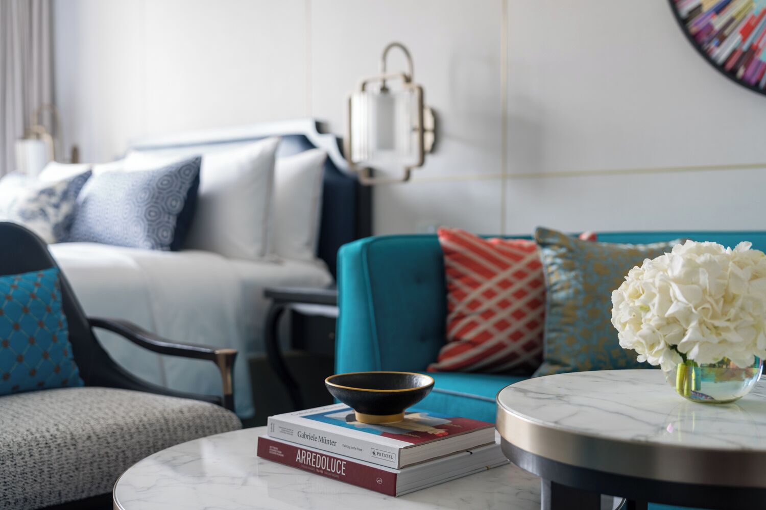 A modern living room with a sofa, armchairs, a coffee table, and a decorative bowl.