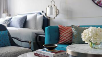 A modern living room with a sofa, armchairs, a coffee table, and a decorative bowl.