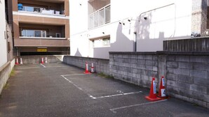 A parking area with marked spaces and traffic cones indicating a restricted zone. - Super Hotel Inn Hakata (Fukuoka)