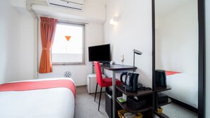 A hotel room with a bed, a desk with a computer, a chair, a desk lamp, and a small table with a cup and a book. - Super Hotel Inn Hakata (Fukuoka)