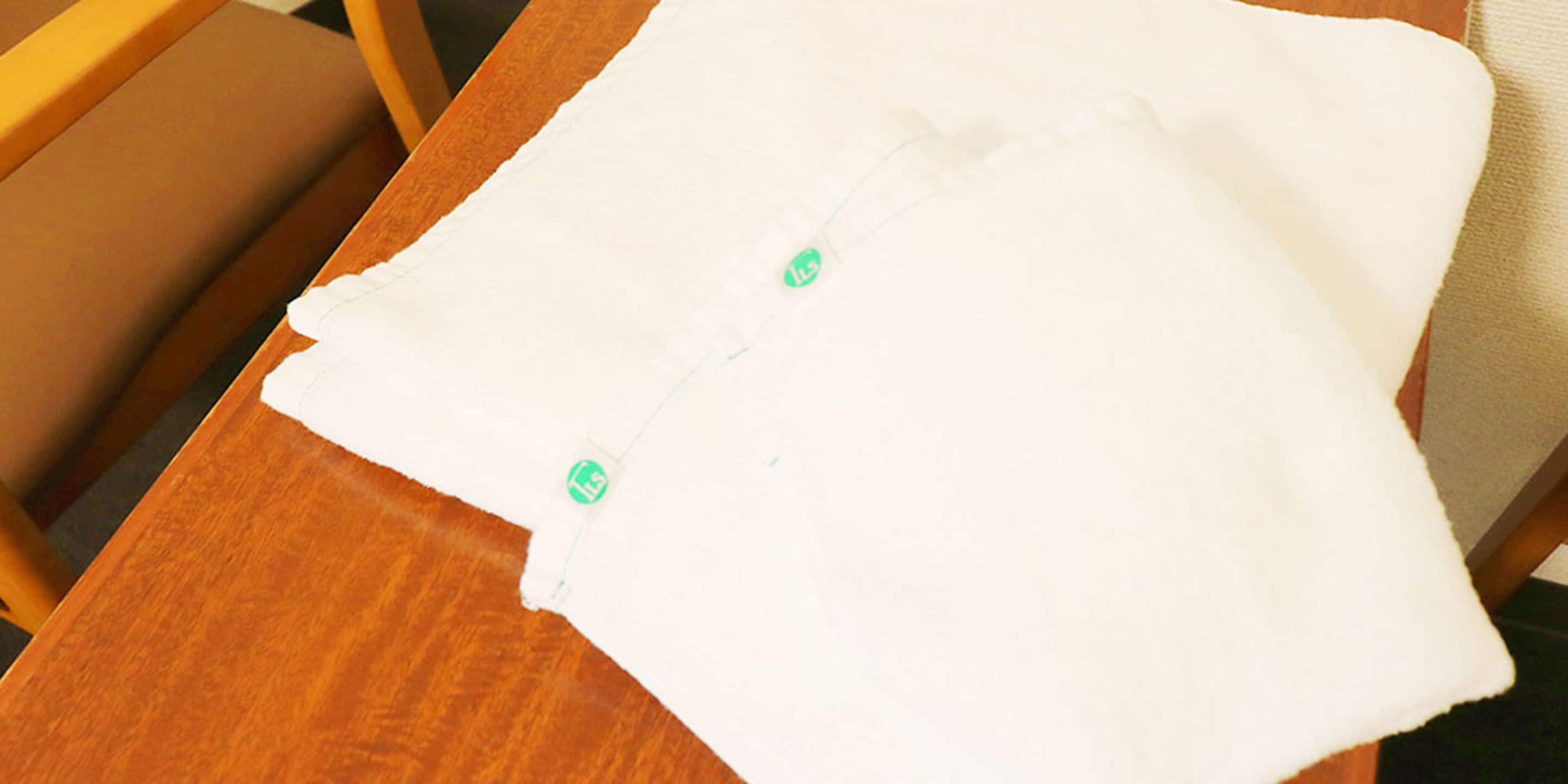 A white piece of paper with a green label on a wooden table.