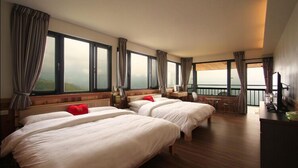 A hotel room with two beds, a small table, a chair, and a balcony with a view. - Stream Yurt Campground (Ren'ai)