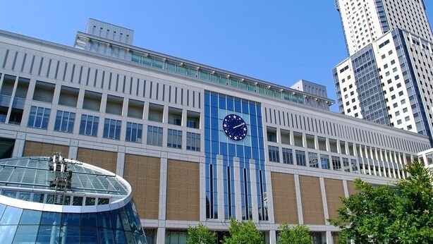 A modern building with a large clock on the facade, surrounded by other high-rise buildings. - Lestel Maru - Hostel (Sapporo)