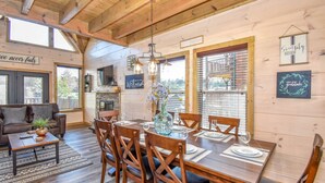 Un interior rústico de madera con comedor, sofá y chimenea.