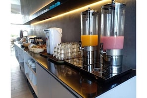 Enjoy a convenient breakfast at the hotel's well-equipped breakfast bar, featuring a coffee maker and juice dispensers.