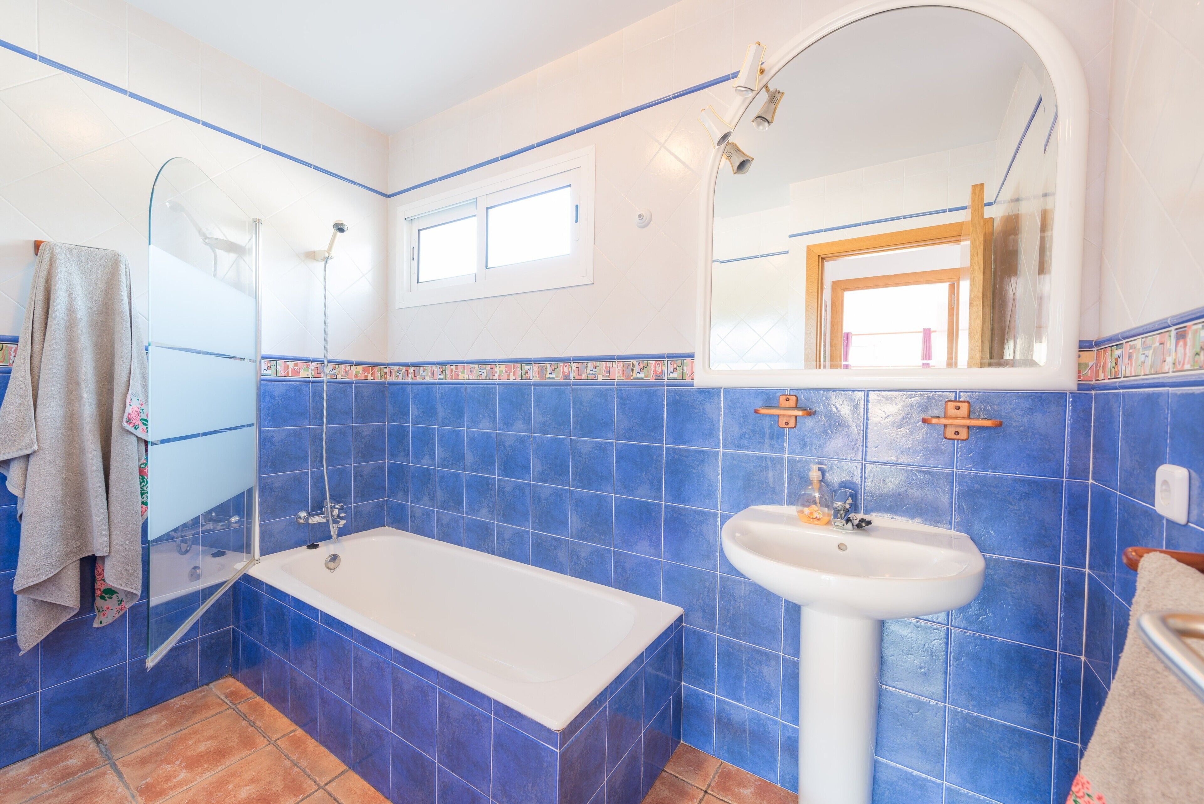 A bathroom with a bathtub, a sink, and a shower.