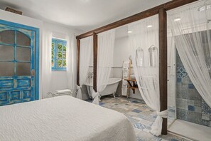 A bathroom with a bathtub, a shower, and a toilet.