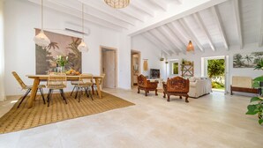 A spacious living area with a dining table, chairs, and a sofa. - Can Torres. Your charming villa in the heart of Mallorca. (Pòrtol)