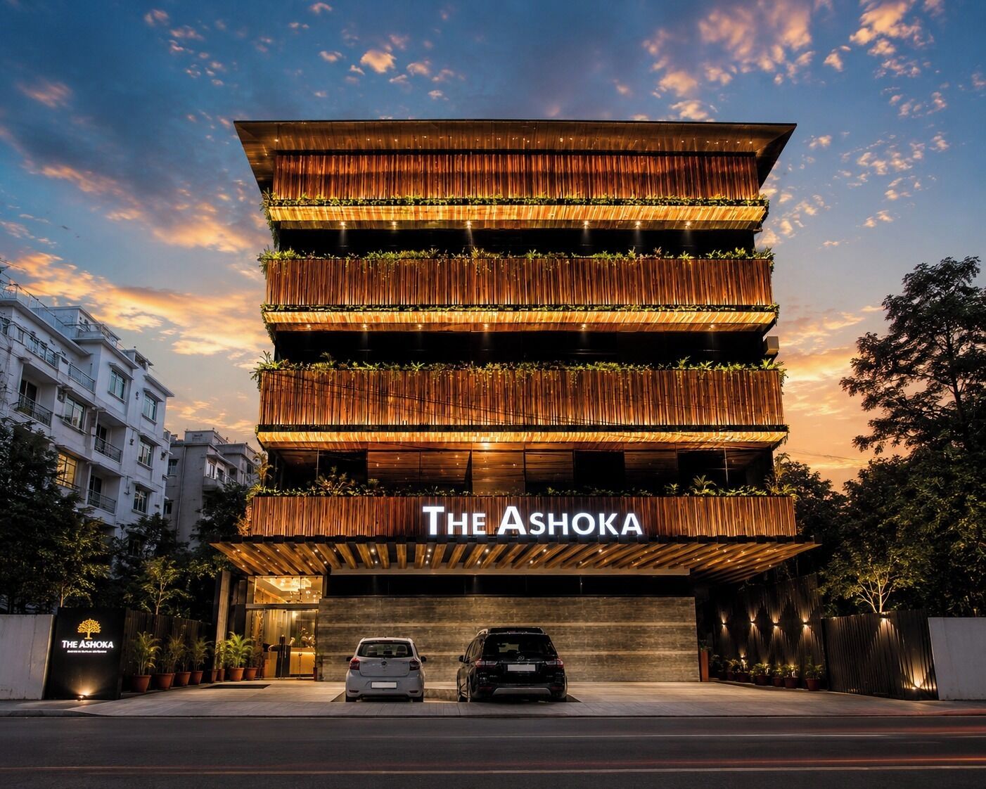 A multi-story hotel with a modern design, featuring a prominent entrance and a sign that reads 'The Ashoka.'
