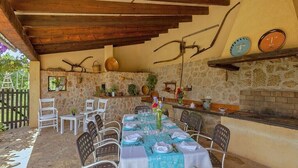 Un espace de restauration en plein air avec des murs en pierre, un plafond en bois et un décor rustique.