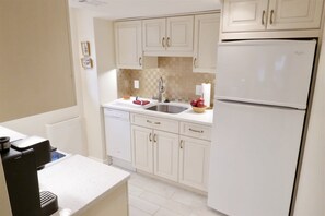 Fridge, microwave, coffee/tea maker, cookware/dishes/utensils