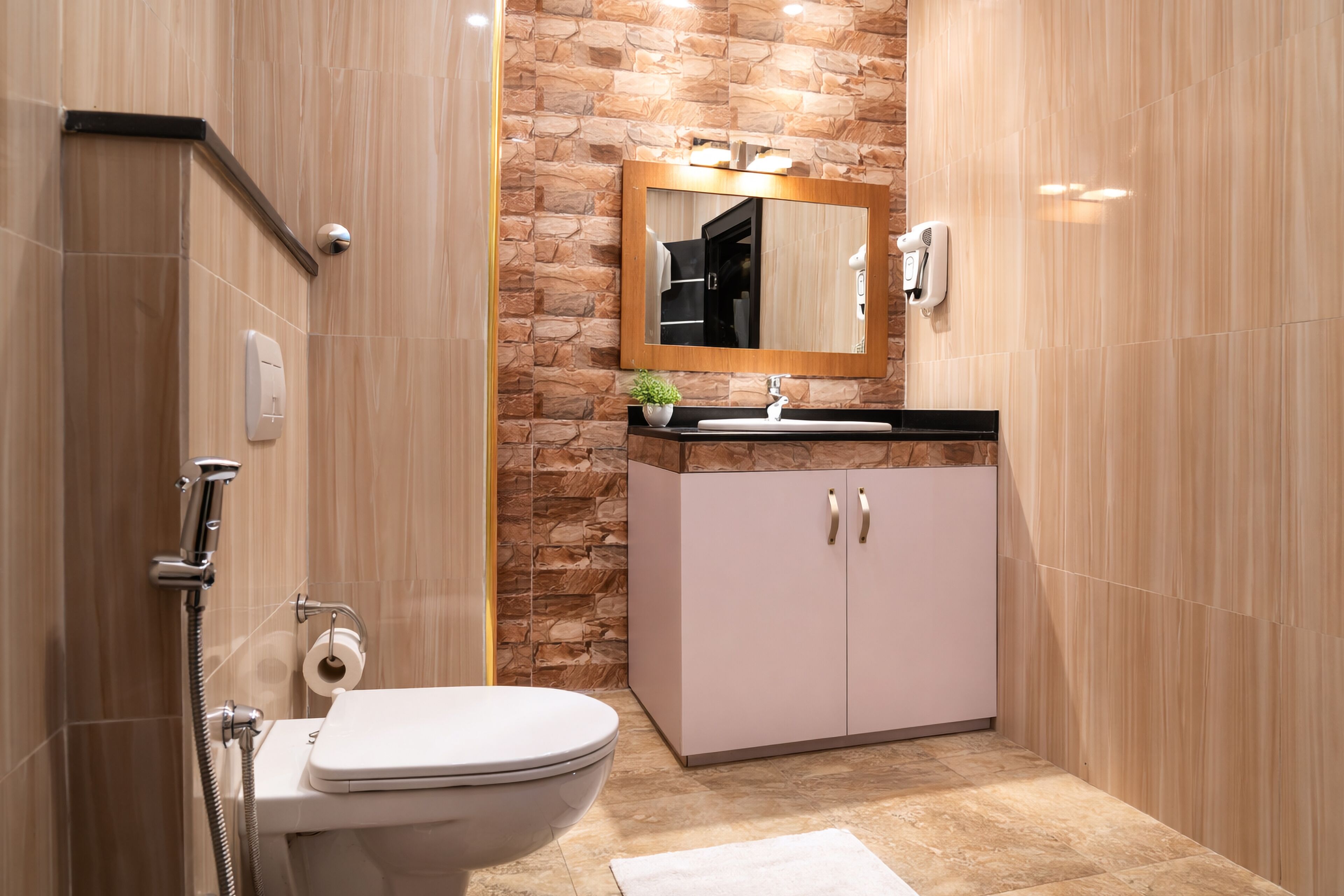 A bathroom with a toilet, sink, mirror, and shower.