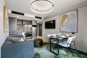 One Bedroom King Apartment | Living area | 40-inch Smart TV with digital channels, TV