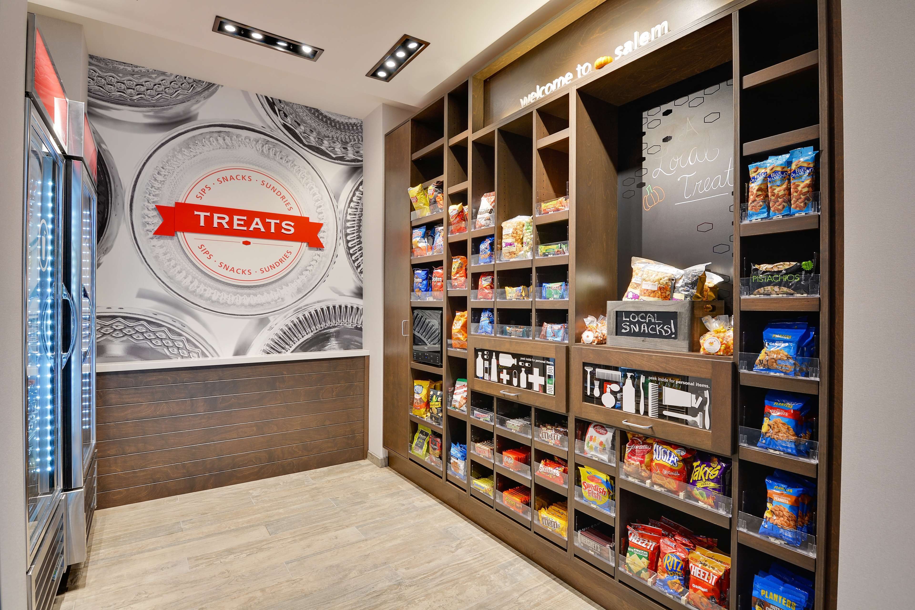 A snack display with a 'Local Treats' sign, featuring various packaged snacks and a 'Local Snacks' sign.