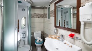 A compact bathroom with a shower, toilet, and sink. - Central Apt With Hydromasage Shower (Hersonissos)